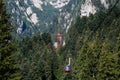 BUSTENI, ROMANIA - AUGUST 2, 2017: Blue cable car cabin transports tourists from Busteni resort up to Bucegi Mountains plateau, Royalty Free Stock Photo