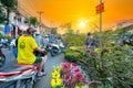 Bustle of locals flowers at flower market sunset sky, Royalty Free Stock Photo