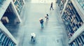 the bustling activity within a warehouse as workers navigate among towering shelves filled with cardboard boxes, seen Royalty Free Stock Photo
