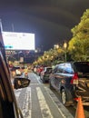 bustling atmosphere on the street with motorbikes and cars on a large highway and people