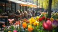 A bustling caf with outdoor seating surrounded by vibrant spring Royalty Free Stock Photo