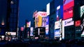 Bustling city street illuminated at night