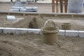 A bustling construction site showcasing buckets and bricks situated on a sandy ground surface Royalty Free Stock Photo