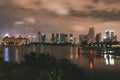 Bustling metropolis at night illuminated by bright lights, with a large lake in Singapore Royalty Free Stock Photo