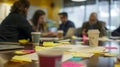 In a bustling office a group of PR spets gather around a conference table intently discussing the latest crisis