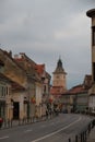 Bustling street featuring a church in the background in Brasov, Romania.