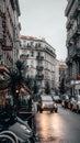 Bustling street scene at dusk with cars lining both sides of the street in Nice, France