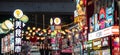 Bustling street scene at night with illuminated signs. Wuhan, China