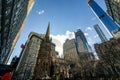 Bustling urban scene featuring tall skyscrapers and the Trinity Church