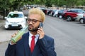 Busy African American man drinking soda while calling