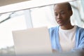 Busy African Black girl student using laptop computer sitting at desk. Royalty Free Stock Photo