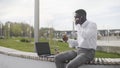 Busy african businessman having lunch and working outdoors Royalty Free Stock Photo