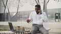 Busy african businessman having lunch and working outdoors Royalty Free Stock Photo