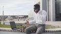 Busy african businessman having lunch and working outdoors Royalty Free Stock Photo