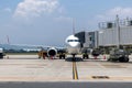 A busy airport tarmac runway with various commercial aircraft planes parked near the terminals Royalty Free Stock Photo