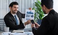Busy analyst team discussing financial data on laptop and phone. Fervent Royalty Free Stock Photo