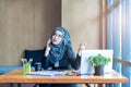 Busy asian muslim business woman talking on mobile phone Royalty Free Stock Photo