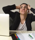 Busy attractive woman in business suit working in stress screaming desperate overwhelmed Royalty Free Stock Photo
