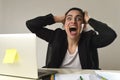 Busy attractive woman in business suit working in stress screaming desperate overwhelmed Royalty Free Stock Photo