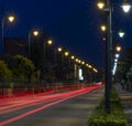 Busy avenue with light trails of cars in the blue hour