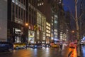 Busy Avenue in New York Manhattan at Night. Street and Stores Dressed in Christmas Mood with Bright Light Decoration Royalty Free Stock Photo