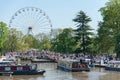 Large ferris wheel and canal boats and barges on a summer day in UK Royalty Free Stock Photo