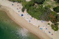 Busy beach goers day between the water and trees Royalty Free Stock Photo