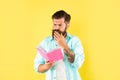 busy bearded man with book on yellow background, erudition