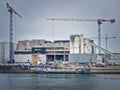 Busy building site near Seine river with cranes working and a barge on the water, Asnieres, Paris, France Royalty Free Stock Photo