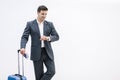 Busy businessman suitcase looking at his watch in the airport over white background.