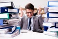 The busy businessman under stress due to excessive work