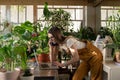 Busy businesswoman, freelancer or female gardener work on laptop, make mobile calls in home garden