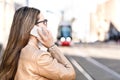 Busy businesswoman having a phone call while waiting for tram Royalty Free Stock Photo