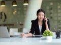 Busy businesswoman on the phone with customer