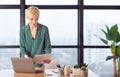 Busy Businesswoman Reading Business Papers Standing At Workplace In Office Royalty Free Stock Photo