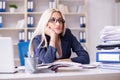 The busy businesswoman working in office at desk Royalty Free Stock Photo