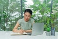 Busy businesswoman writing in an agenda on a desktop at office Royalty Free Stock Photo