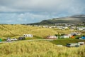 Busy caravan park with many tents, motor homes and caravans, Warm sunny day.