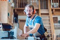 Busy carpenter at the circular cutter working with wood Royalty Free Stock Photo