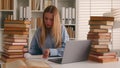 Busy Caucasian student girl stressed leaner pupil woman studying with laptop and books homework learning online search