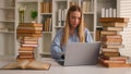Busy Caucasian student girl stressed leaner pupil woman studying with laptop and books homework learning online search Royalty Free Stock Photo
