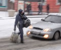 Busy city people on zebra crossing in motion blur. Winter snowy day, dangerous situation