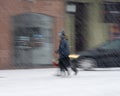 Busy city people on zebra crossing in motion blur. Winter snowy day, dangerous situation