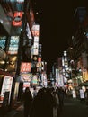 Busy city street with neon signs and tall buildings in Tokyo, Japan Royalty Free Stock Photo