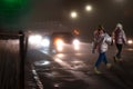 Busy city street people on zebra crossing at night. Dangerous situation Royalty Free Stock Photo