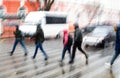 Busy city street people on zebra crossing in a rainy day. Dangerous situation. Defocused image Royalty Free Stock Photo