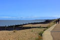 A busy coastal pathway alongside the pebbled beach at Tankerton