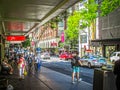 Busy Colorful Downtown CBD streets with man people walking on sidewalks