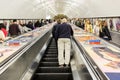 Busy commuters on elevators of an underground station in London, UK Royalty Free Stock Photo