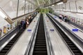 Busy commuters on elevators of an underground station in London, UK Royalty Free Stock Photo